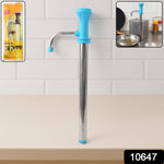 Using manual oil pump dispenser pouring cooking oil in kitchen