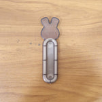 Self stick push pull helper shown firmly attached to cabinet surface