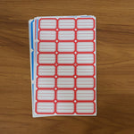 Backing side of writable label stickers showing strong adhesive layer