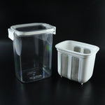 Complete yogurt maker set with strainer basket and lid ready for use.