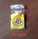 Angled view of the yellow duck hot water bag, highlighting its portable design.