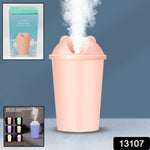 Portable mini humidifier operating in a cozy home setting, emitting a fine mist.