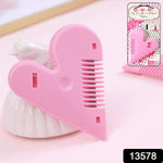 Pair of heart-handled hair scissors on white background