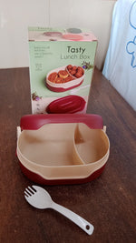 Compact airtight tiffin box with spoon, ideal for travel.