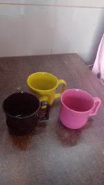 An empty plastic coffee mug ready for use, showcasing its sturdy base and comfortable grip.