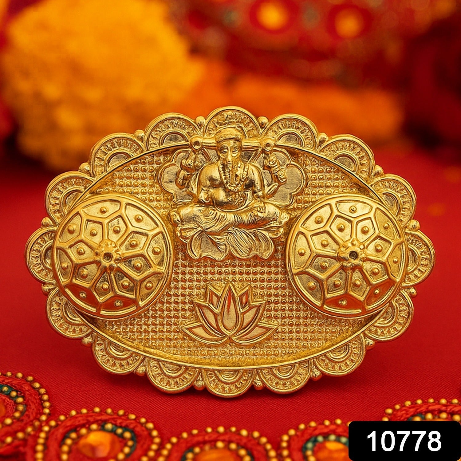Close-up of Ganesh embossed kumkum chopra showing intricate lotus and Ganpati motifs