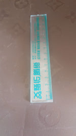 Packaging for transparent 15cm plastic scale with green text