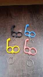 Multi-angle view of dual-finger mobile stand keyring showing sturdy plastic build