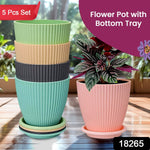 Five black plastic flower pots arranged together, perfect for home gardening and decor.