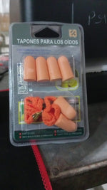 Comfortable soft foam earplugs displayed on a wooden table.