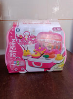 Child pulling the closed portable kids kitchen play set suitcase