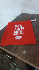 Clothes stored neatly inside a red drawstring bag, perfect for travel.