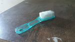 Plastic scrubbing brush featuring an ergonomic handle design.