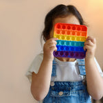 Rainbow colored push bubble fidget toy in assorted random shapes
