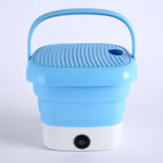 Mini folding washer on a clean background, highlighting its compact size for travel.
