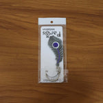 Peacock feather metal keychain shown in lifestyle setting with keys