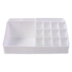 Pull-out drawer of the clear makeup organiser holding compacts and small items.