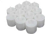 Several LED tealight candles illuminating a dark setting, showing their warm glow.