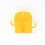 Mobile phone stand with hook holding phone and hanging accessories on wall