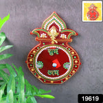 Close-up of decorative wooden Kalash wall hanging with stone and pearl accents