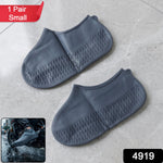 A pair of flexible, small silicone shoe covers displayed on a clean surface.