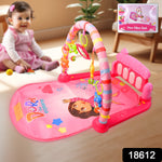 Infant kicking the musical piano on the Aditi baby play gym mat.
