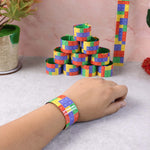 Various snap slap bracelets lined up with vibrant patterns