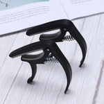 Wagtail guitar capo showcasing its pick holder and soft stand features.